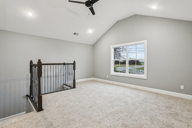 unfurnished room featuring ceiling fan, carpet, and vaulted ceiling