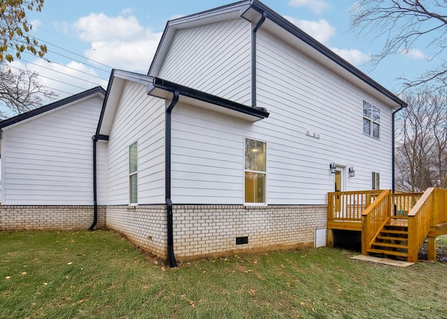 view of side of property with a yard and a deck