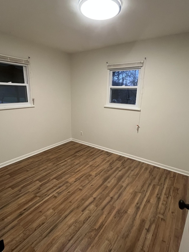 empty room featuring dark hardwood / wood-style flooring