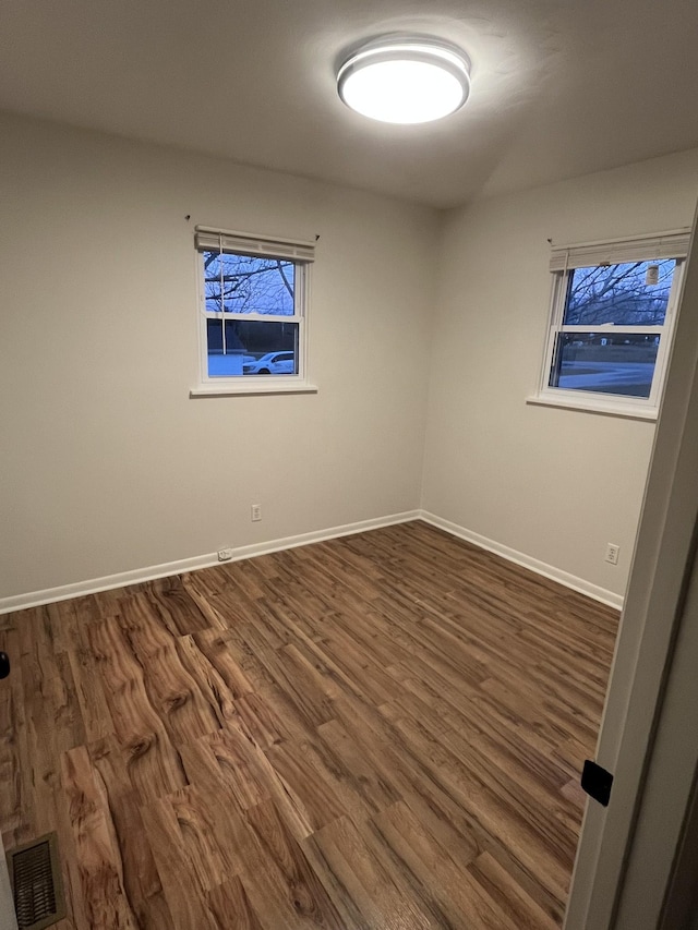 unfurnished room featuring dark hardwood / wood-style floors