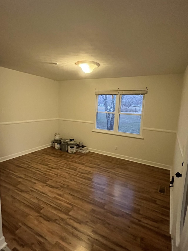 spare room featuring dark hardwood / wood-style floors