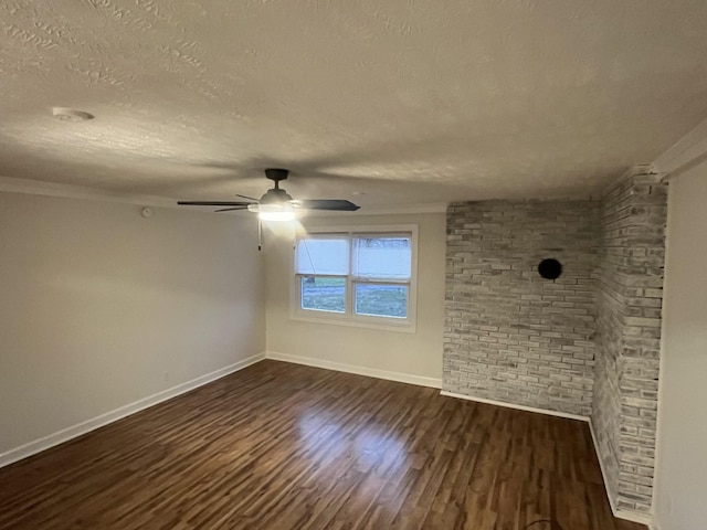 spare room with a textured ceiling, crown molding, ceiling fan, and dark hardwood / wood-style floors