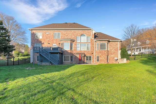 rear view of house featuring a yard and a deck