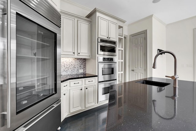 kitchen featuring tasteful backsplash, stainless steel double oven, fridge, and ornamental molding