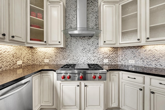 kitchen with appliances with stainless steel finishes, backsplash, and wall chimney exhaust hood