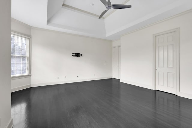 unfurnished room featuring hardwood / wood-style flooring, ceiling fan, ornamental molding, and a tray ceiling