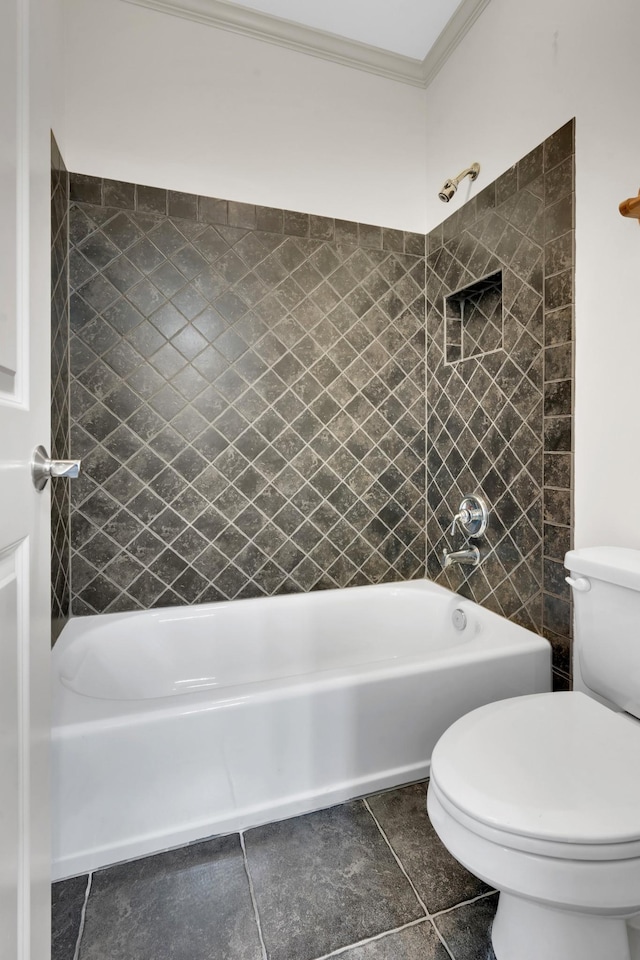 bathroom featuring tile patterned floors, toilet, tiled shower / bath combo, and ornamental molding