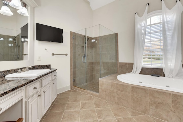 bathroom with tile patterned floors, a wealth of natural light, vanity, and plus walk in shower