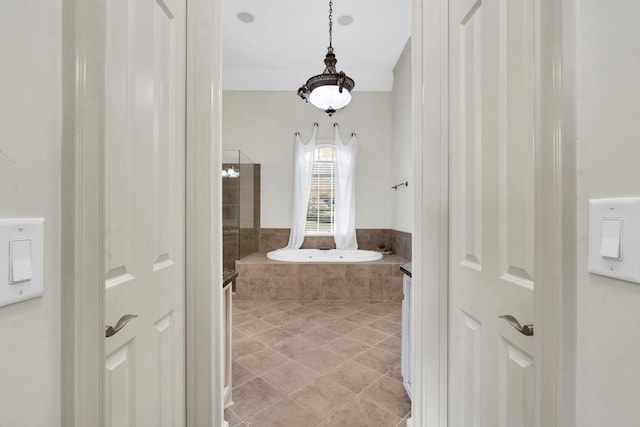 bathroom with tile patterned floors and tiled tub