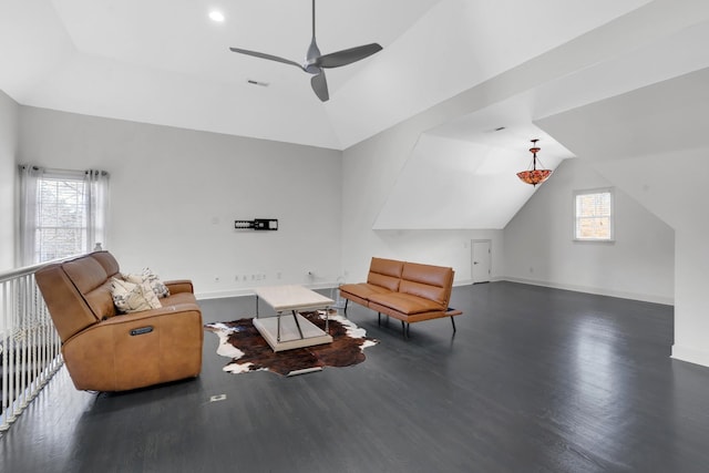 living room with ceiling fan, dark wood-type flooring, a healthy amount of sunlight, and lofted ceiling