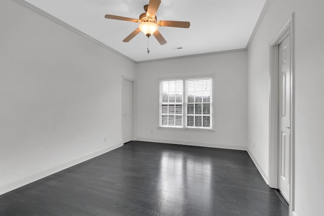 empty room featuring crown molding, dark hardwood / wood-style flooring, and ceiling fan