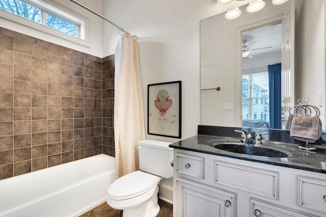 full bathroom featuring plenty of natural light, ceiling fan, toilet, and shower / bathtub combination with curtain