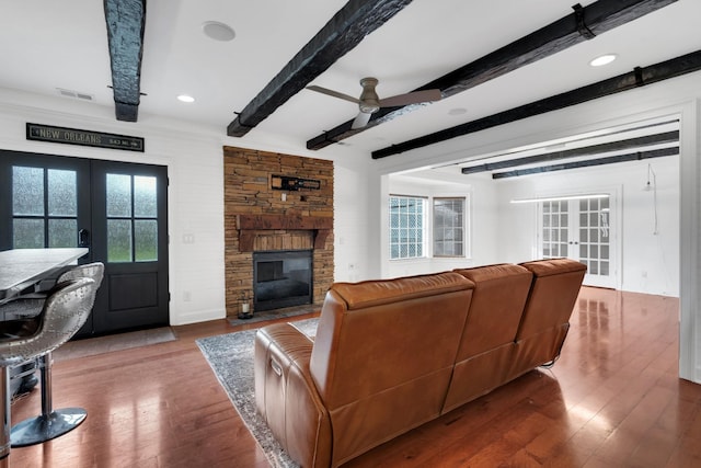 living room with beam ceiling, ceiling fan, french doors, and wood-type flooring