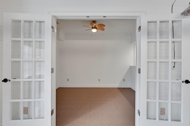 carpeted empty room featuring ceiling fan