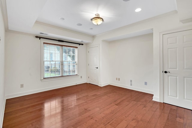 spare room with wood-type flooring and ornamental molding