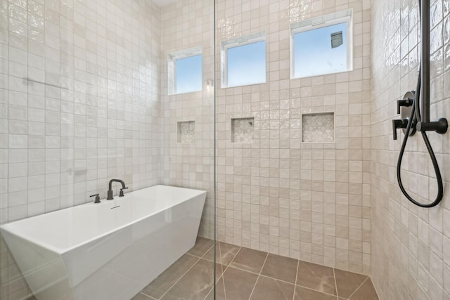 517 Matthew Miller Dr, Smyrna, TN 37167 - full bath with tile walls, a freestanding bath, a tile shower, and tile patterned flooring