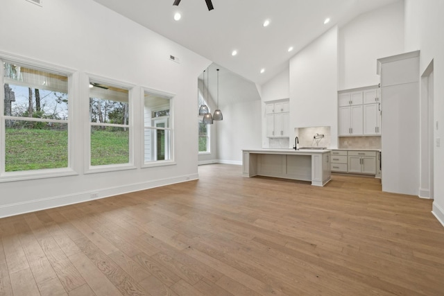 517 Matthew Miller Dr, Smyrna, TN 37167 - unfurnished living room with a ceiling fan, light wood-type flooring, high vaulted ceiling, and recessed lighting