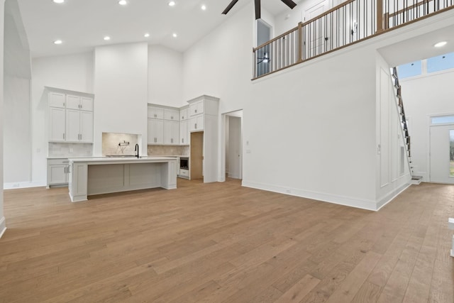 517 Matthew Miller Dr, Smyrna, TN 37167 - unfurnished living room featuring a high ceiling, a ceiling fan, light wood-type flooring, and recessed lighting