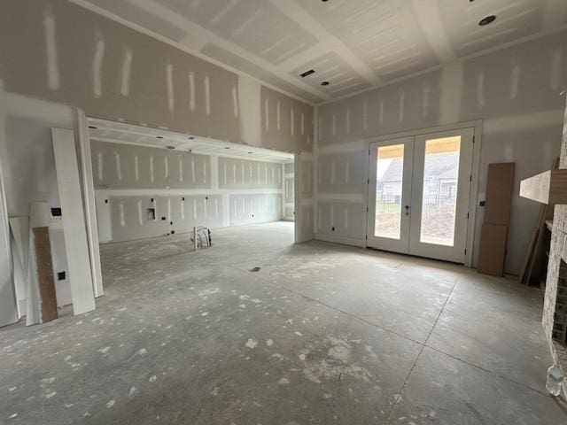 unfurnished living room featuring a fireplace and french doors