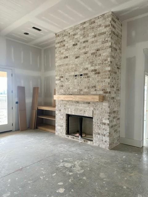 unfurnished living room with a high ceiling, a brick fireplace, unfinished concrete floors, and visible vents