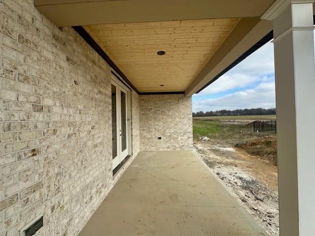 view of patio / terrace with a rural view and french doors