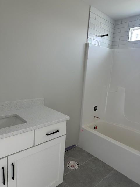 full bath featuring tile patterned flooring, tub / shower combination, and vanity