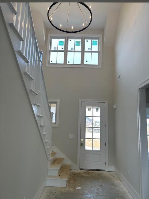 foyer with a high ceiling, a wealth of natural light, and baseboards