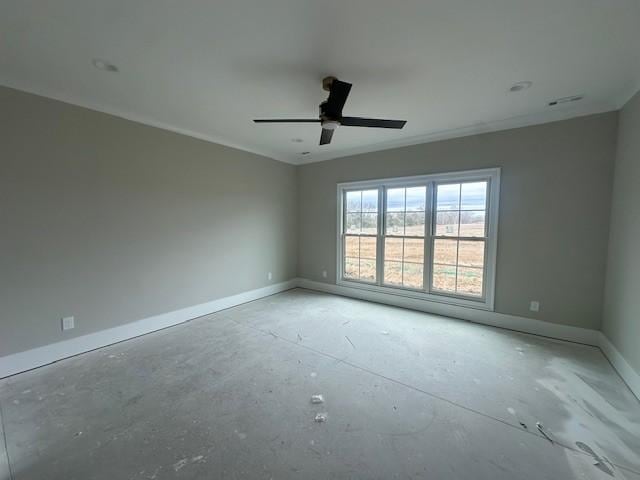 empty room featuring a ceiling fan and baseboards