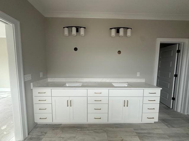 bathroom with ornamental molding and vanity