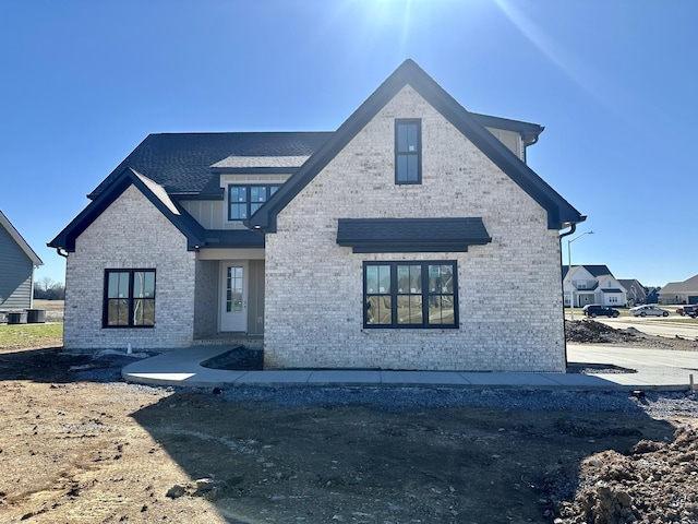 view of front of house with brick siding