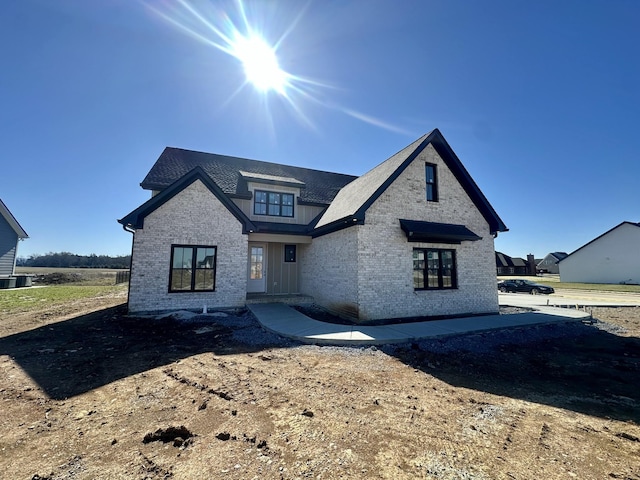 view of front of home featuring brick siding