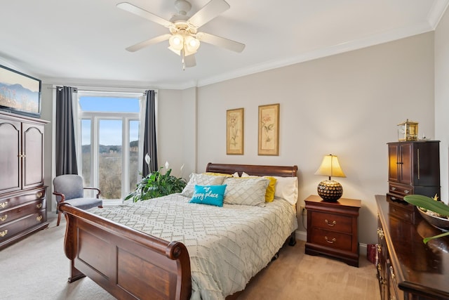 carpeted bedroom with ceiling fan and crown molding