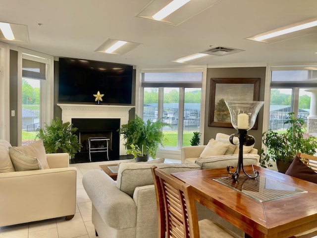 living room featuring floor to ceiling windows, light tile patterned floors, and a wealth of natural light