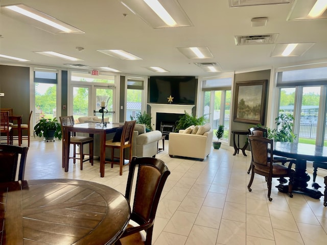 interior space with expansive windows, a healthy amount of sunlight, and french doors