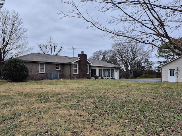 exterior space with a lawn and central AC unit