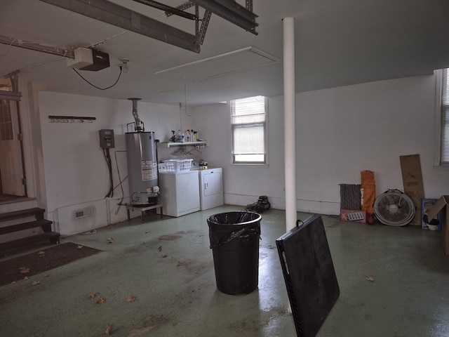 basement featuring water heater and independent washer and dryer