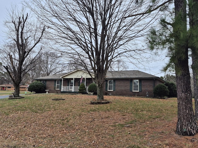 ranch-style house with a porch and a front lawn