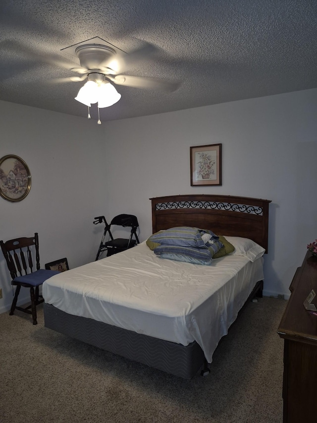 carpeted bedroom featuring ceiling fan and a textured ceiling