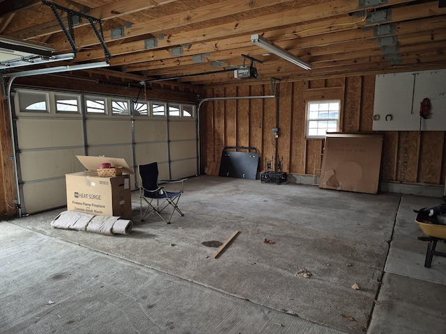 garage with a garage door opener and a carport