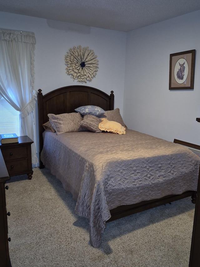 carpeted bedroom featuring a textured ceiling