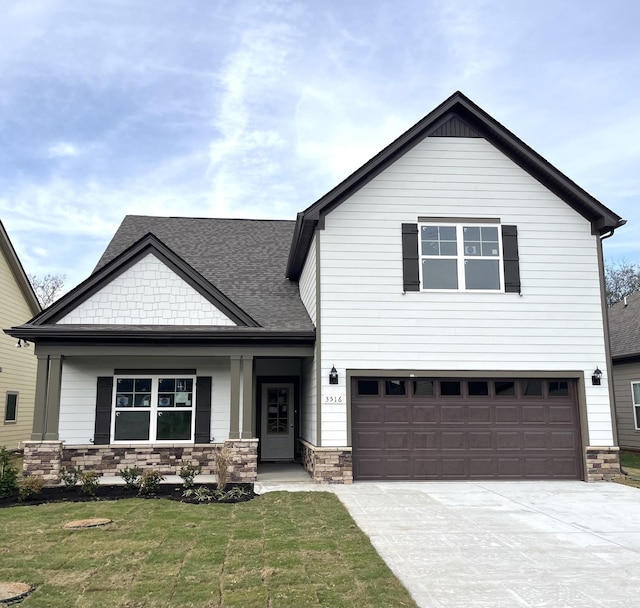 view of front of home with a garage and a front lawn