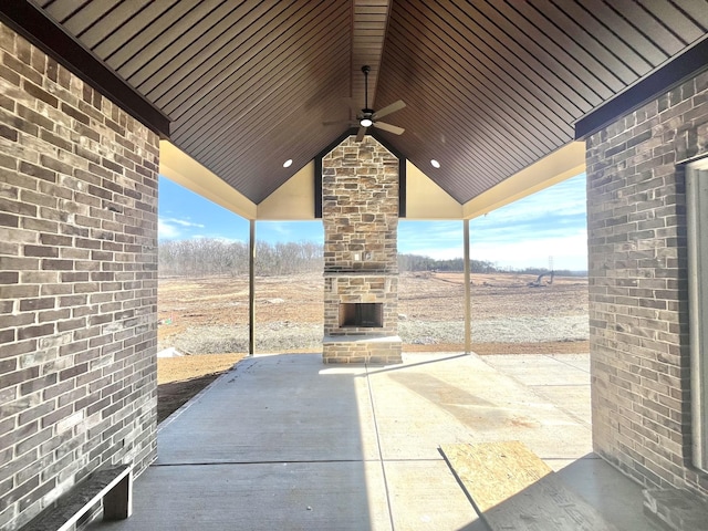 view of patio / terrace with a fireplace and a ceiling fan