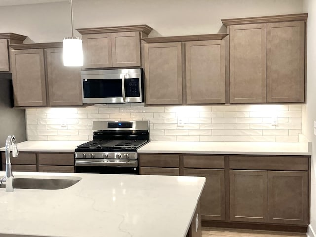 609 Spring Hill Dr, Smyrna, TN 37167 - kitchen with appliances with stainless steel finishes, tasteful backsplash, and hanging light fixtures