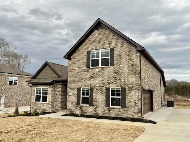 609 Spring Hill Dr, Smyrna, TN 37167 - rear view of property with driveway, a garage, and brick siding