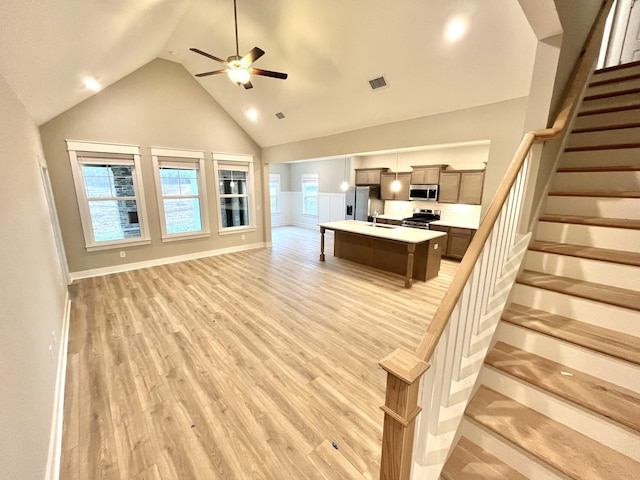 609 Spring Hill Dr, Smyrna, TN 37167 - living room with light wood-style floors, ceiling fan, stairs, and high vaulted ceiling