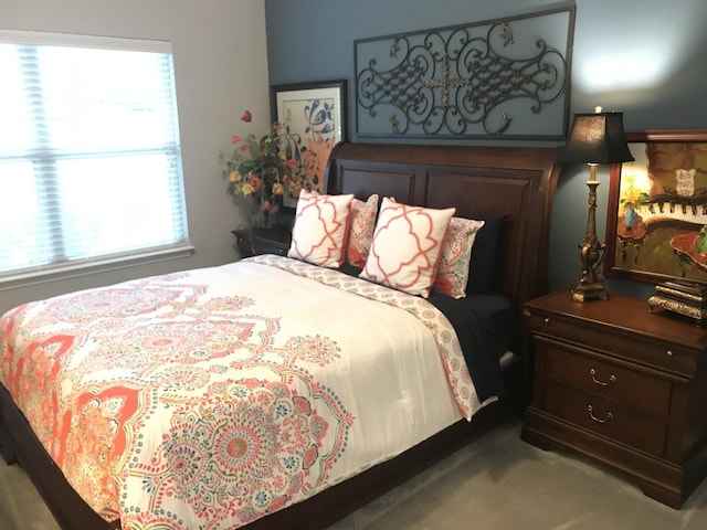 carpeted bedroom featuring multiple windows