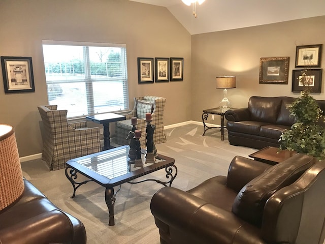 living area with lofted ceiling, carpet, and baseboards