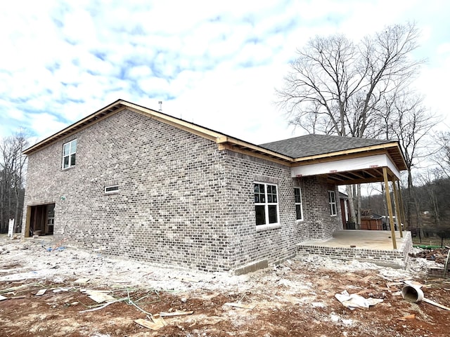 rear view of house with brick siding