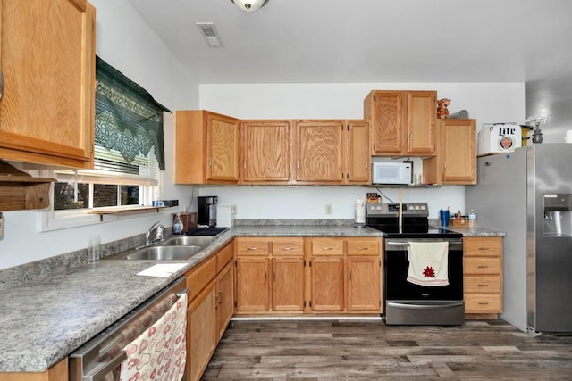 kitchen with sink, dark wood-type flooring, and appliances with stainless steel finishes