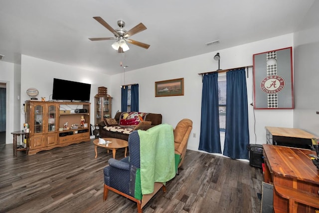 living room featuring ceiling fan and dark hardwood / wood-style flooring